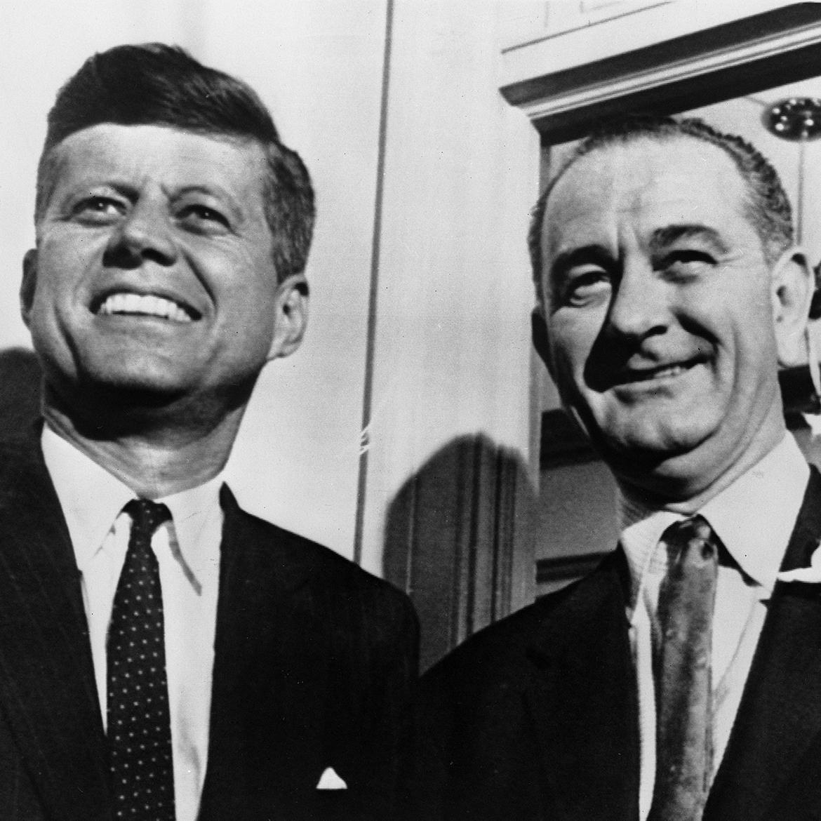 John F. Kennedy and Lyndon B. Johnson in medium closeup, both smiling.
